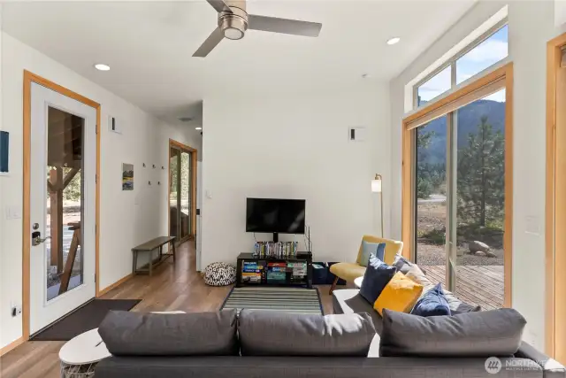 Plank flooring, wooden trim details and high ceilings, super large windows brings the outside in.