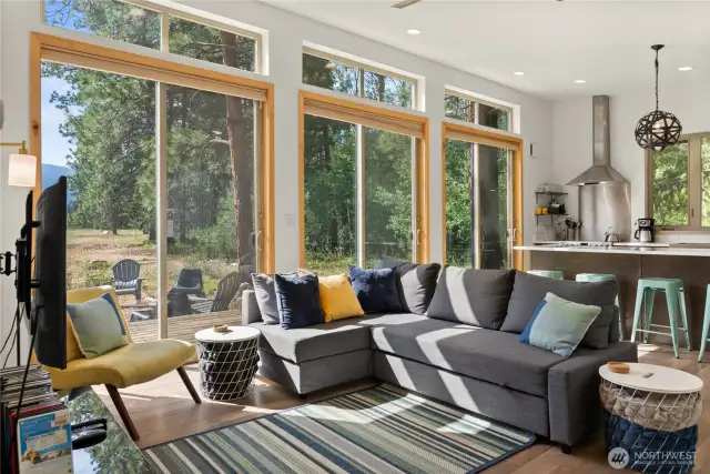 Open-concept living room filled with light and mountain views, perfect for relaxing or entertaining.