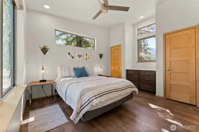 Primary bedroom retreat — Vaulted ceiling, modern fan, and private ensuite with abundant natural light.