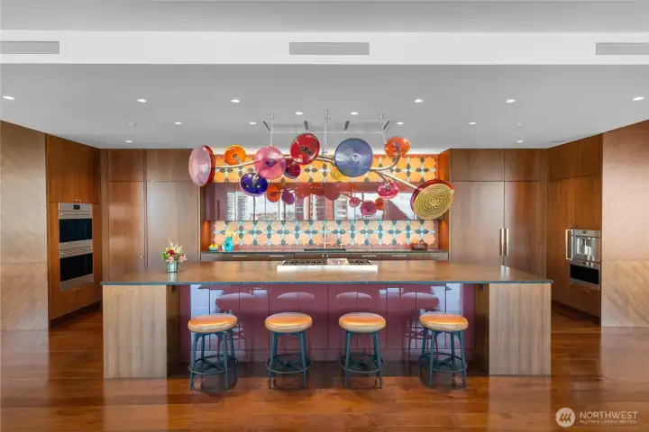 Substantial island to anchor your culinary creations. Antique leathered brown granite countertops, plentiful storage and a Moroccan Tabarka tile backsplash by Ann Sacks. Concealed Zephyr range hood over 6 burner (+griddle) Wolf. 2 Wolf ovens (with convection). 2 Cove dishwashers. Sub-Zero refrigerator, freezer + additional refrigerator drawers. Microwave. Espresso maker. Dornbracht ultra-hot and cold filtered water dispenser.