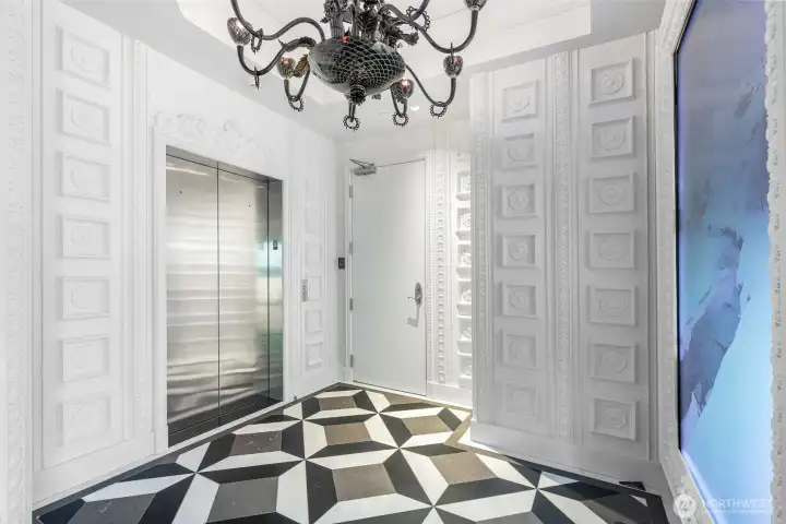One of two secure elevator vestibules. Arrive to custom black-glass fire breathing dragon light-as-art with hidden gem. Egg and dart moulding. 98" commercial display (currently showing Blackdove art). Ann Sacks honed custom-mosaic marble. Your guests will be glad they came.