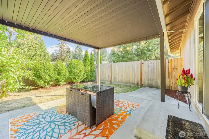 Entertain as space inside and outside flow together between sliding door and louvered pergola.
