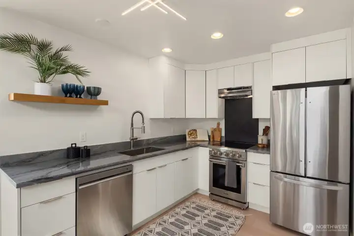 All new stainless appliances. Custom black herringbone tile backspace behind range