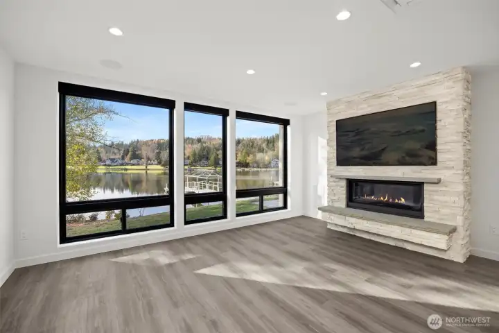 The spacious living room has a wall of floor-to-ceiling windows that take in the stunning lake views.