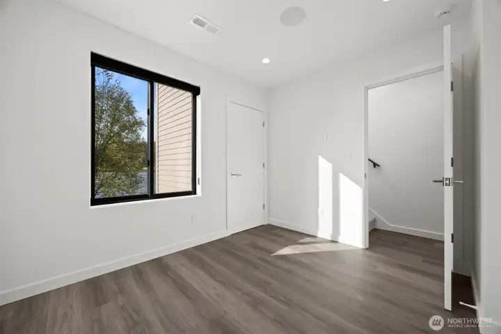 The bedroom on the main floor takes in the views of the lake and has a large closet.