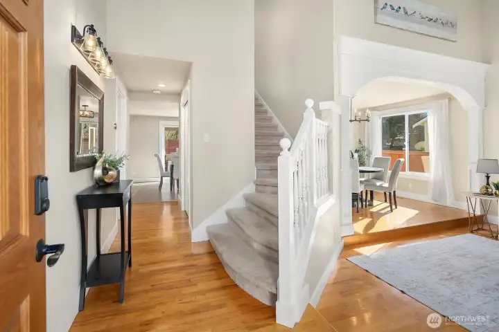 Entry with hardwoods and vaulted ceiling.