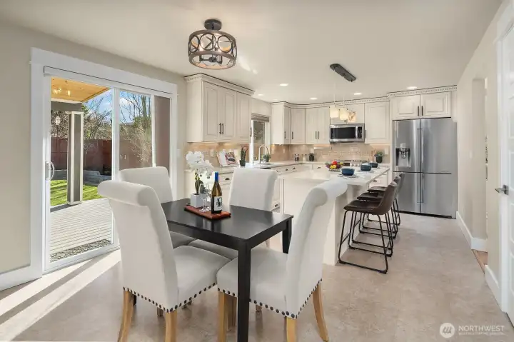 View of informal dining and kitchen area along with spacious covered composite deck