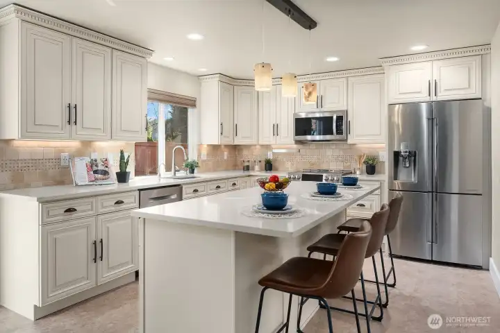 Kitchen with upgraded cabinets, counter tops, recessed lighting, stainless appliances including double oven.