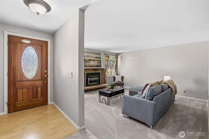 On entry, an open foyer with coat closet.  Living room with natural gas fireplace.