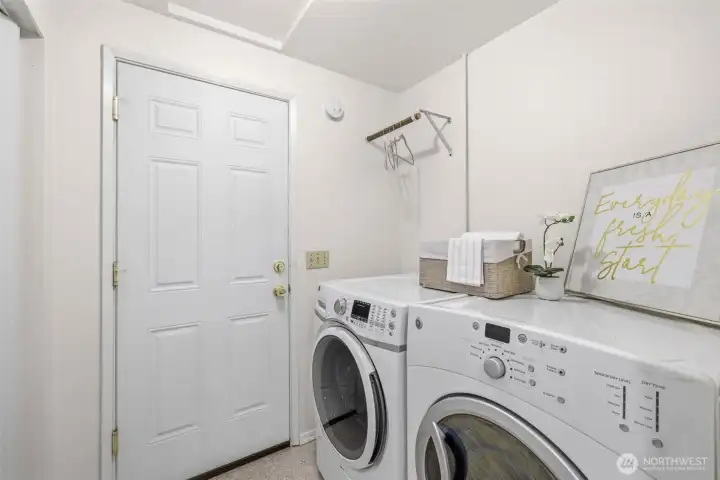 Laundry room is a pass through to the three-car garage. Washer and dryer stay with home.