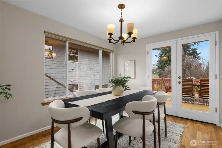 Spacious dining room features French doors that open to an incredible deck.