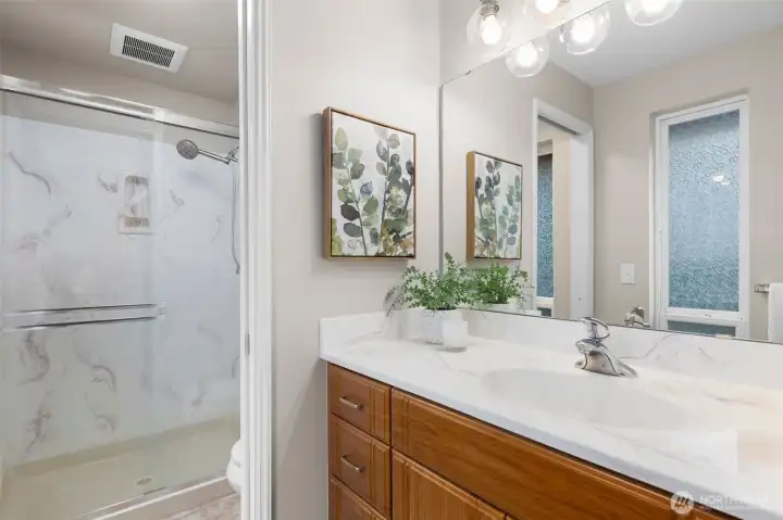 3/4 bathroom in primary suite.