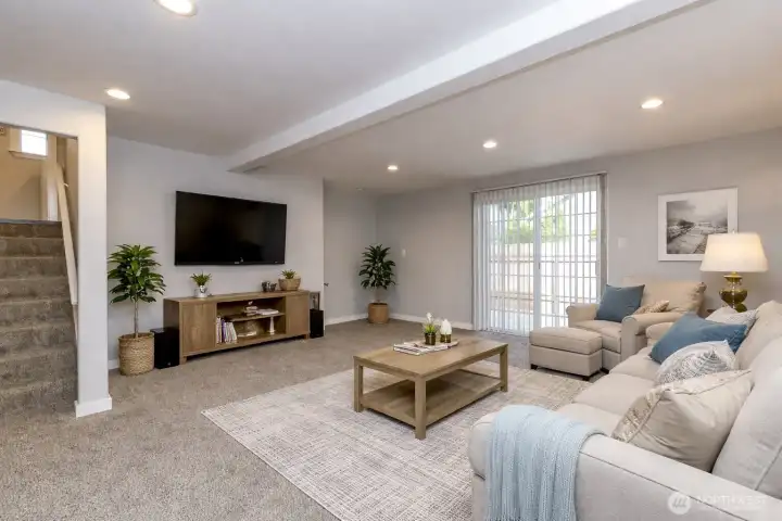 The family room has been completely remodeled blending modern comfort with timeless warmth. A gas fireplace provides a cozy centerpiece for gatherings and relaxing evenings. Sliding glass door invites abundant natural light and opens to a patio. Fresh, updated finishes and thoughtful design create a bright, inviting space.  Virtually staged