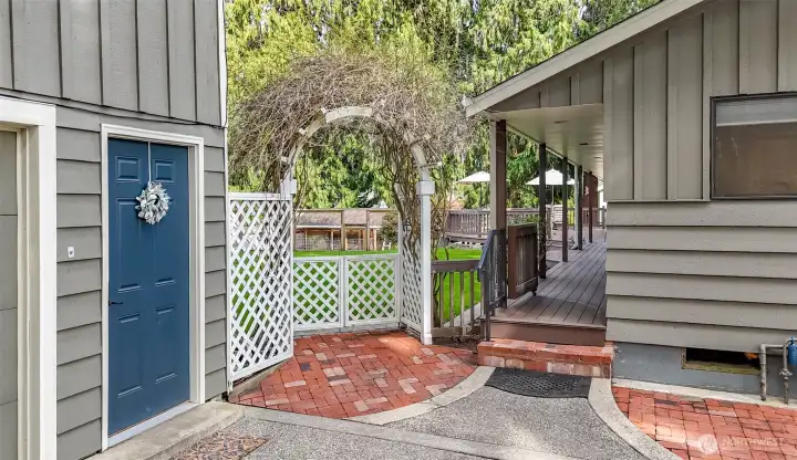 Enter into your private backyard oasis with brick pavers and a private shaded entryway
