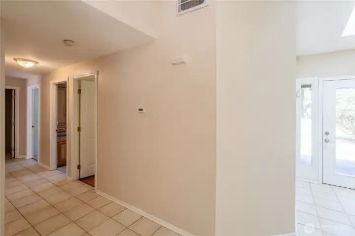 Hallway between kitchen & bedrooms leading to garage.