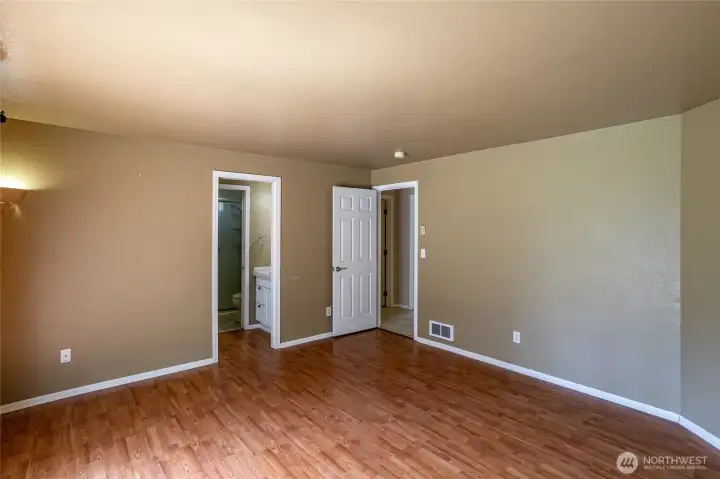 Primary bedroom entry to private bathroom.