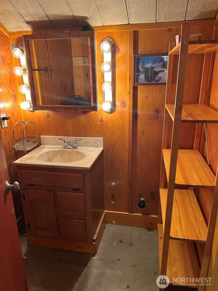 bathroom in Party Barn guest house - toilet and shower thru door by shelf unit