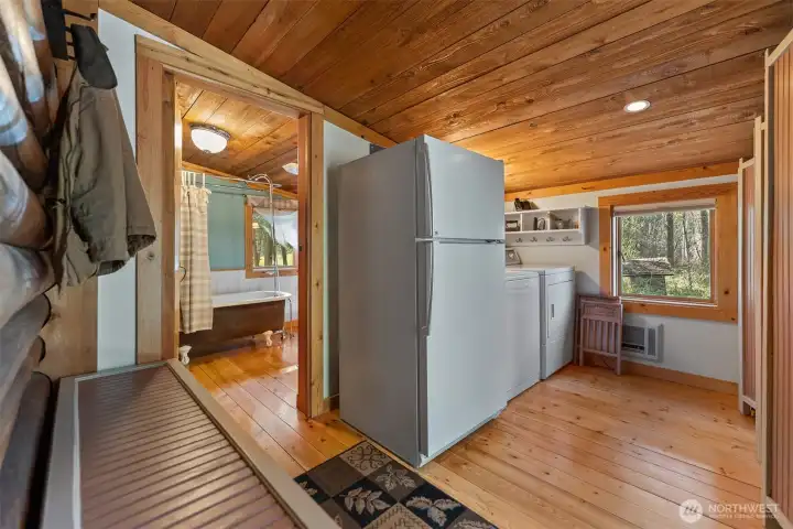 Enter into a spacious mudroom/laundry. room with adjacent full bathroom.