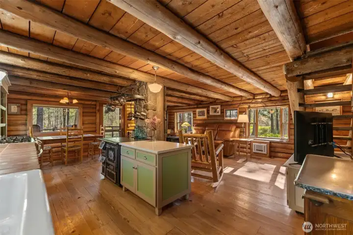 The main kitchen and living area is one large space centered around a stone chimney with propane heating stove.