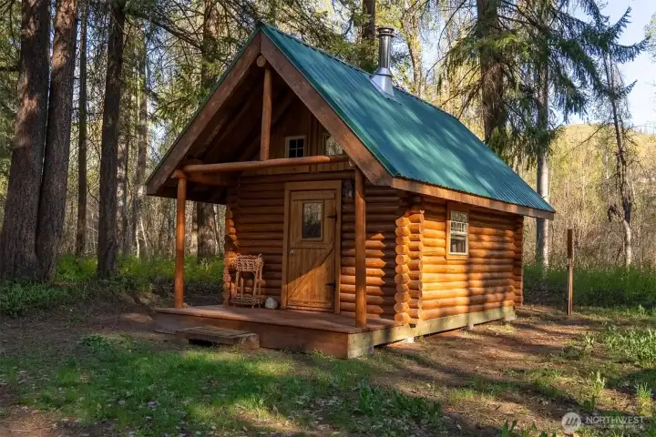 This custom log cabin (dry) provides overflow sleeping space for guests or could be used as an office, artists studio, etc.
