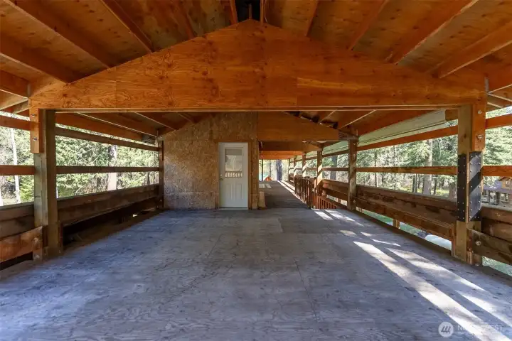 Loft for hay storage includes additional enclosed storage space.