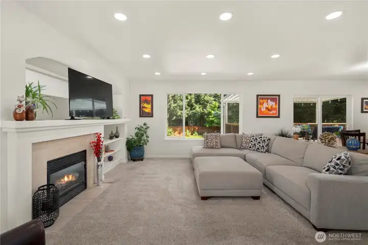 Cozy gas fireplace, built ins, recessed lighting and a beautiful picture window looking out at your one of a kind back yard.