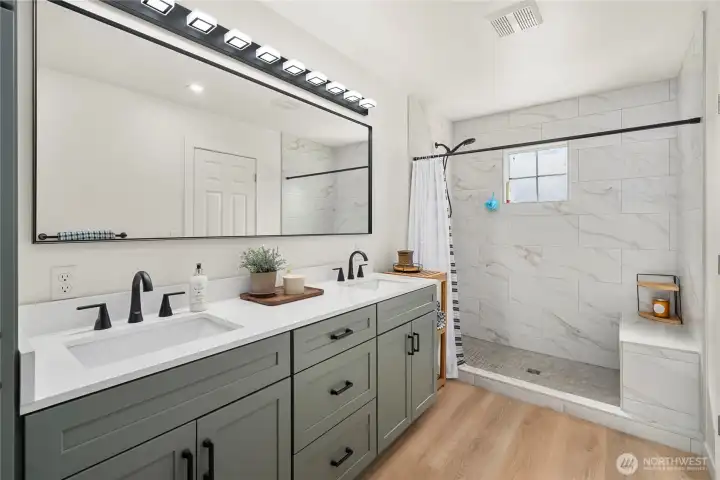 Primary bath with spa like bath, dual vanity and extra large shower with bench seat.