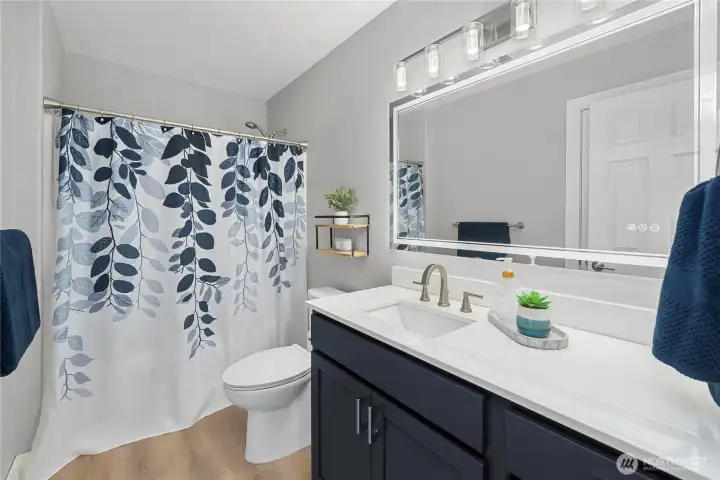 Beautifully updated full bath with quartz counters and designer finishes.