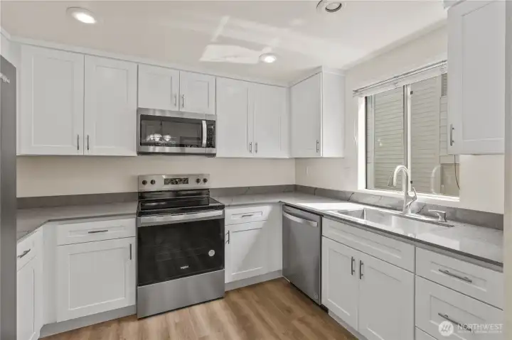 Unit B remodeled kitchen with new quartz counters and new appliances. Unit B remodeled kitchen with new quartz counters and new appliances.