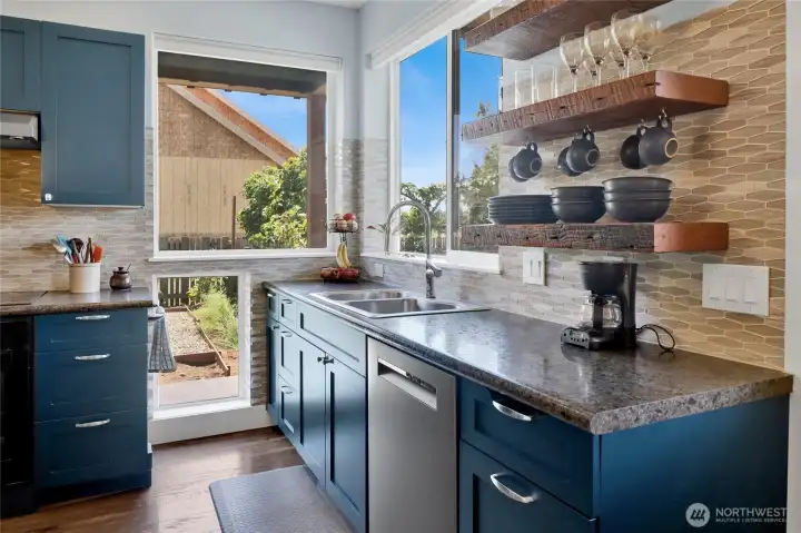Natural light pours into the kitchen through numerous windows, making it feel warm, open, and welcoming.