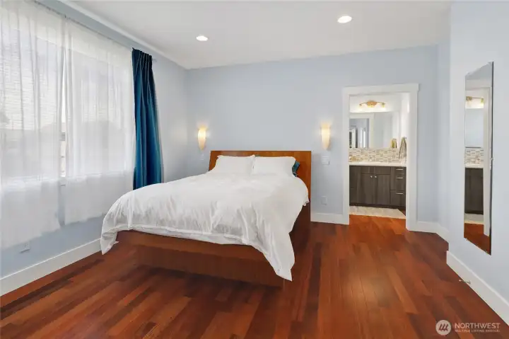 The main-floor primary bedroom provides a peaceful retreat with an attached bathroom and walk-in closet designed for easy everyday living.