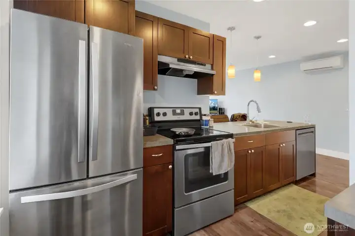 The private ADU is equipped with modern comforts including LVP flooring, a full kitchen, full bathroom, one bedroom, and a ductless mini-split system to keep the space comfortable in every season.