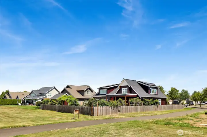 Surrounded by fruit trees and connected to a peaceful community park, this simple fenced yard offers a safe place for children and pets to play, along with a spacious toolshed for storage and hobbies.