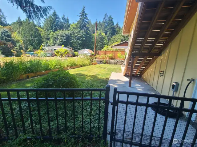 Fenced part of backyard with flowerbeds