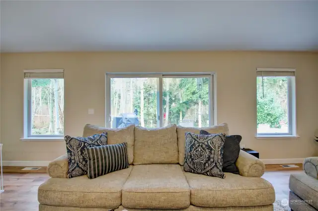 Living area leads to slider out to the natural wooded backyard