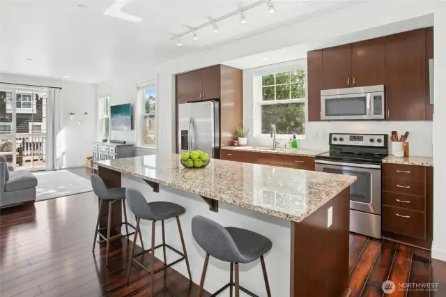 Modern open concept floor plan on the main level. Solid granite slab island and hardwoods too.