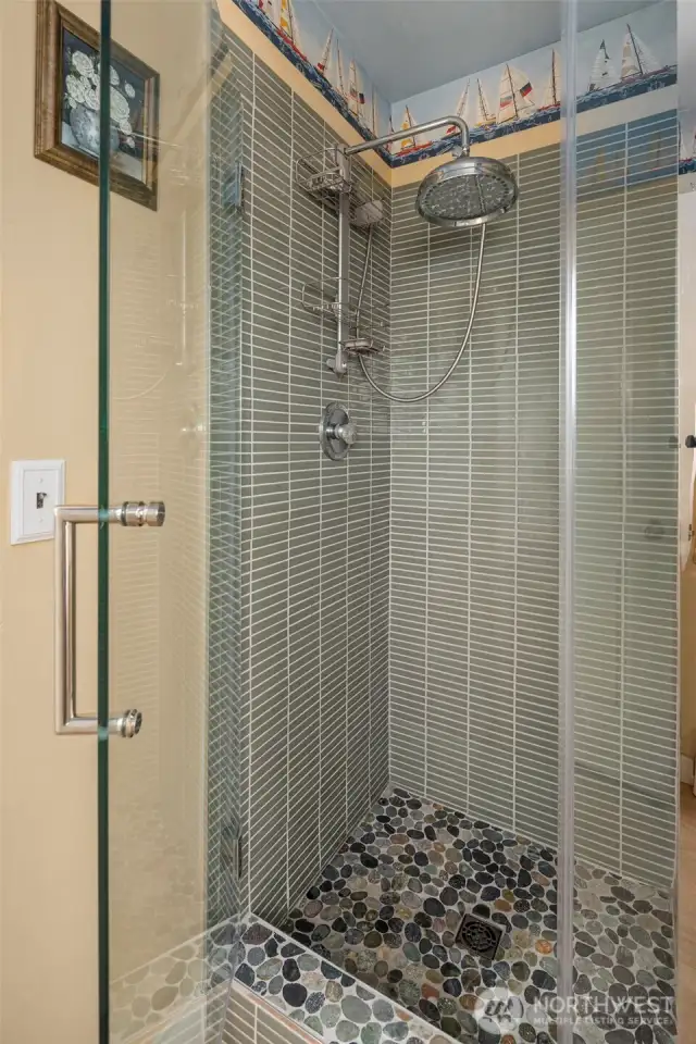 Newly tiled shower and frameless glass shower door