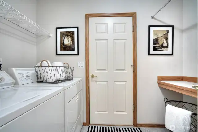Laundry room with storage connects to garage