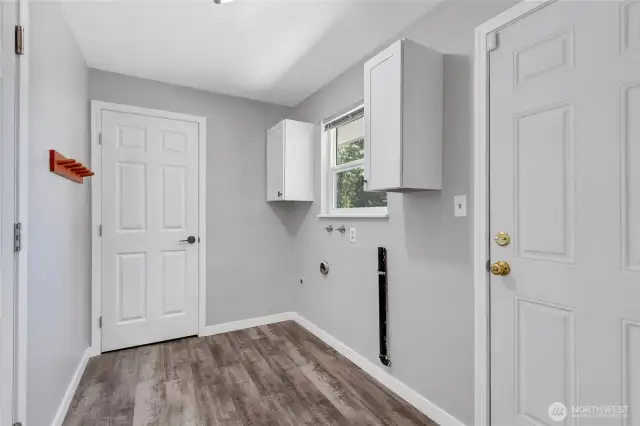 This versatile laundry/mudroom offers extra storage and access to the backyard—perfect for busy households. Fresh paint, updated cabinets, and durable flooring make this space as functional as it is stylish.