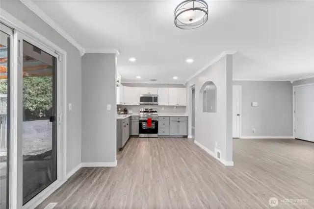 The open layout offers sightlines from the kitchen to the front door, creating great flow for everyday living. Dual-tone cabinetry and crown molding add subtle sophistication to the modern finishes.