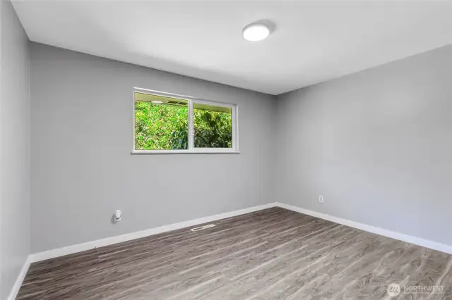 A peaceful retreat with tranquil backyard views, fresh paint, and durable flooring. Ideal for guests, kids, or as an additional office—this room is ready to adapt to your needs.