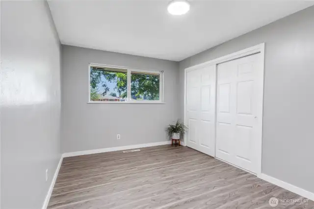 Third bedroom, highlighting its double closet doors and abundant natural light. Clean lines and neutral tones make it a breeze to style.