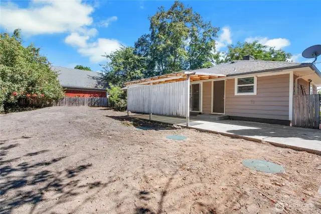 Spacious and full of potential, this backyard is a blank slate ready for a garden, play area, or custom landscaping. The covered patio extends your outdoor living space year-round.
