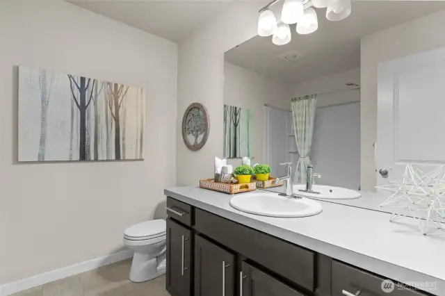 Full en-suite guest bathroom with sleek finishes and tub/shower combo for versatile use.