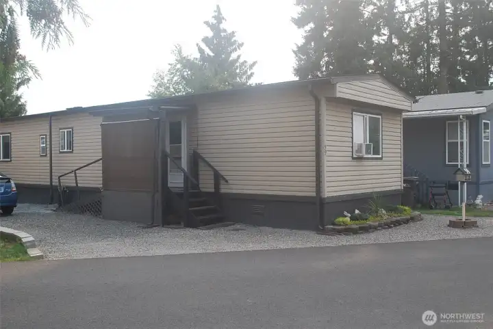 Side of the home showing stairs and ramp