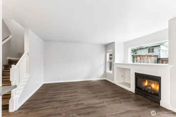 The main living room has a nice, warm fireplace for a warm, cozy winter night and the Luxury Vinyl Plank flooring goes throughout the downstairs and even down the upstairs hallway.