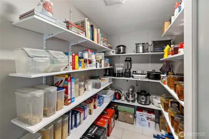 Walk-in pantry. This used to be a full bath across the kitchen. The plumbing is still in place if you choose to convert it back into a bath.
