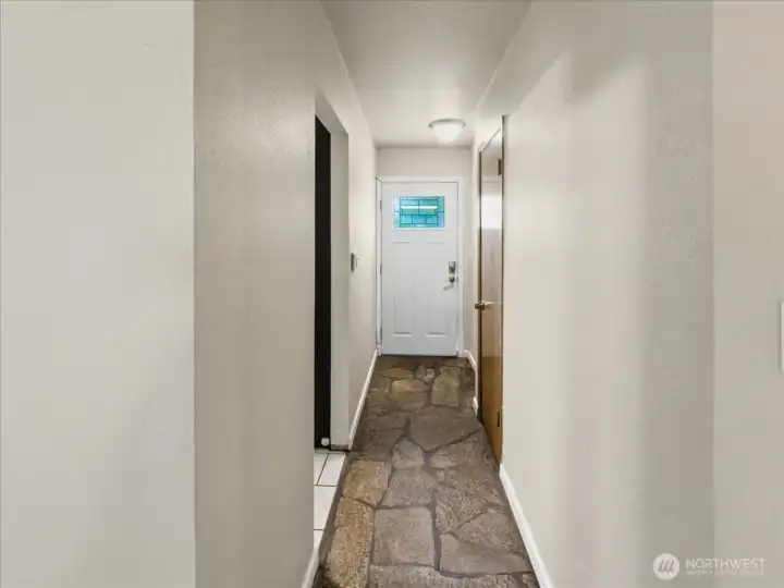 Entrance on the main level with stone flooring.