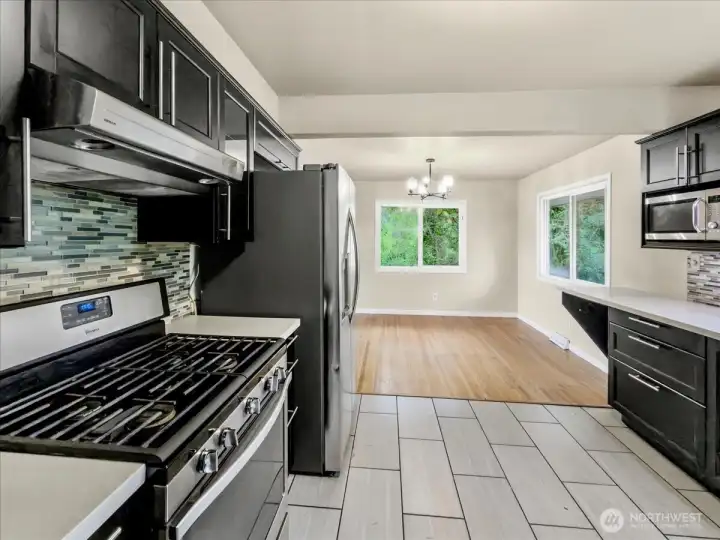 Updated kitchen with quartz counters, tile backsplash and stainless steel appliances. Separate dining area off the kitchen.