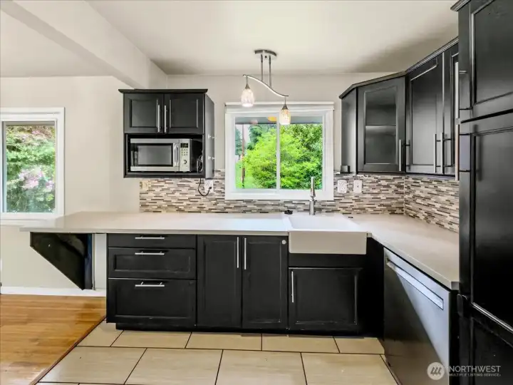 Updated kitchen with quartz counters, tile backsplash and stainless steel appliances. Separate dining area off the kitchen.